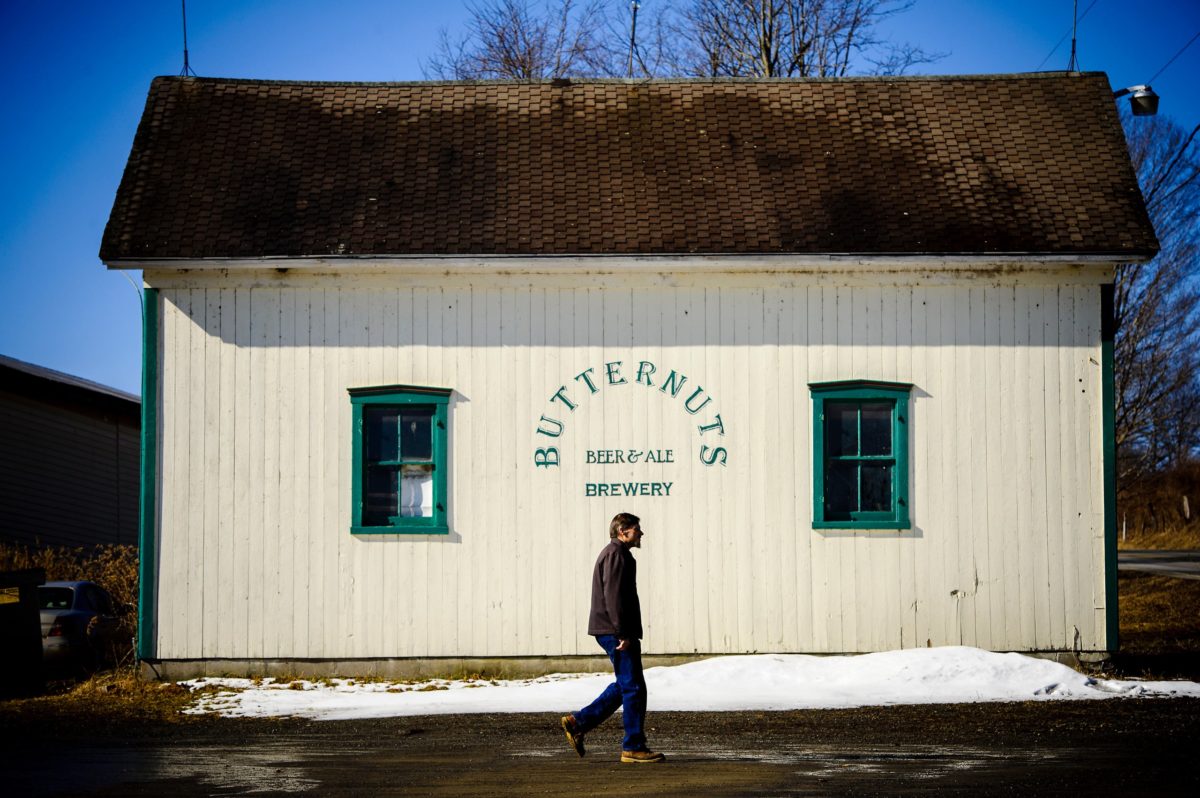 Man walking in  front of barn