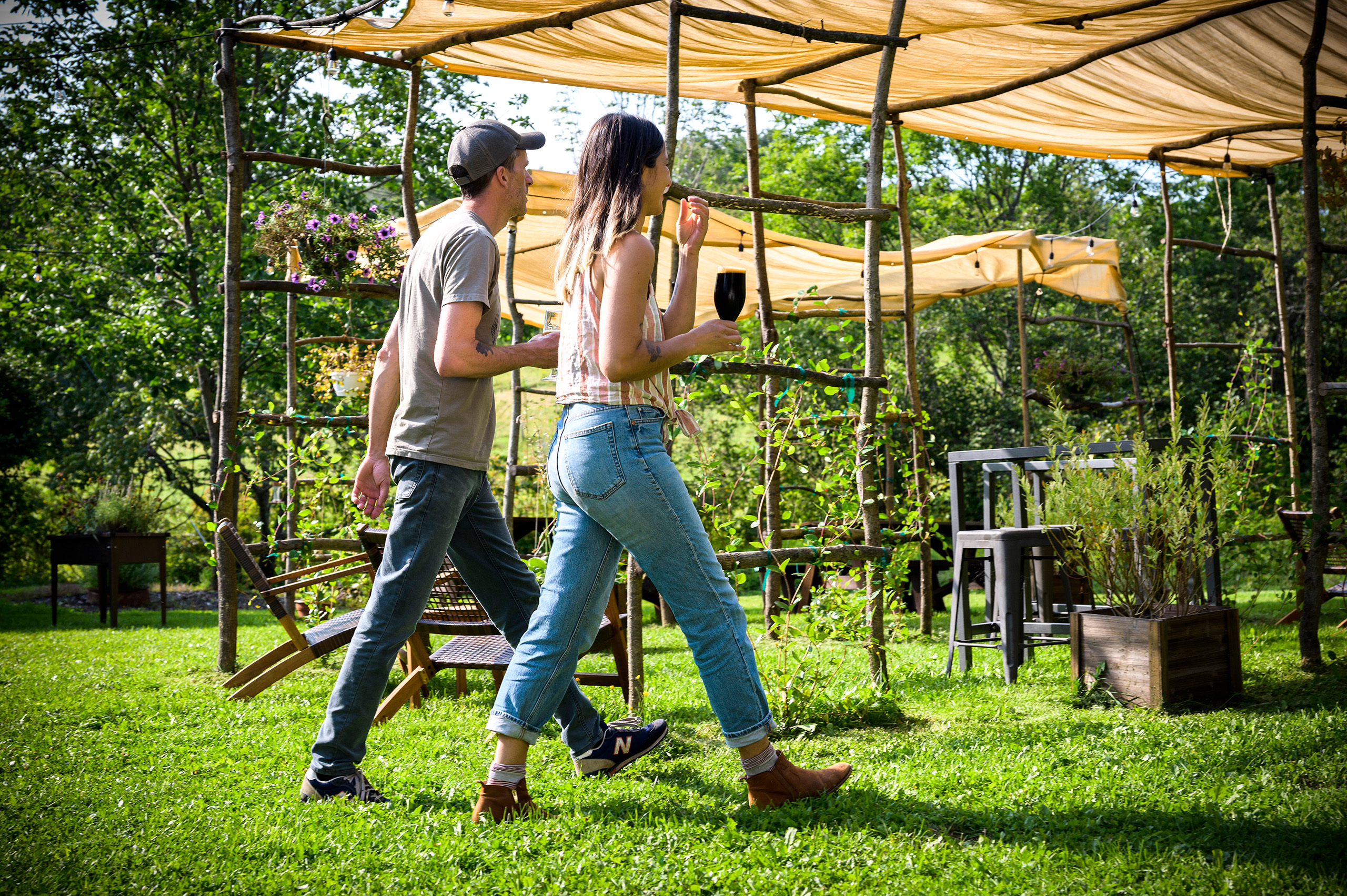 Two people walking with drinks in hand